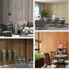 Collage of four different interior design scenes showcasing wood-effect wall coverings and flooring in various settings. Anteprima dell’immagine prodotto