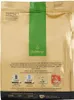 The back of a gold coffee bag with a green vertical stripe and product information. Náhľad obrázku produktu