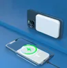 Two iPhones are shown, one with a white power bank attached magnetically, and another with a charging indicator on its screen. Produktbild-Vorschau