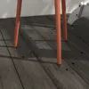 Close-up of the legs of an orange table on a wooden floor. Produktbild-Vorschau