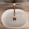 A top-down view of a modern bathroom sink with a copper faucet. Produktbild-Vorschau