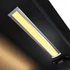 A close-up shot of a modern LED light fixture mounted on a dark surface. Produktbild-Vorschau