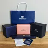 A collection of Festina watch packaging, including a shopping bag, boxes, and documentation, arranged on a wooden surface. Náhled obrázku produktu