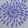 A close-up view of a blue and gray circular pattern on a light gray fabric. Produktbild-Vorschau