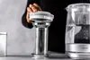 A person is assembling a tea infuser over a kettle. Náhled obrázku produktu