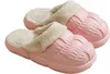Paar rosa flauschige Clog-Hausschuhe mit strukturiertem Obermaterial und dekorativem Knopf an der Seite