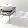 Two kitchen storage shelves are shown, one with a portable induction cooktop and pot on it. Podgląd zdjęcia produktu