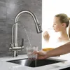A woman drinks water from a glass filled by a kitchen faucet. Náhled obrázku produktu