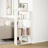 A white bookshelf filled with books and decorative items is placed next to a beige sofa in a living room. Náhled obrázku produktu