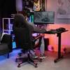 A person is playing a video game in a room with colorful lighting. Náhled obrázku produktu