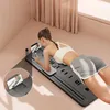 A woman is doing a plank exercise on a Pilates mat with a phone holder. Produktbild-Vorschau