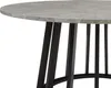A close-up view of a round table with a concrete-look top and black metal legs. Podgląd zdjęcia produktu
