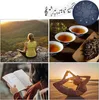 A collage of images related to meditation and relaxation, including a person meditating on a mountain, cups of tea, sheet music and a steel tongue drum, and a person reading a book and doing yoga on a beach. Produktbild-Vorschau
