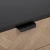 A close-up view of a drawer handle on a piece of furniture. Podgląd zdjęcia produktu