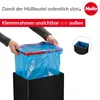 Hands are shown inserting a blue trash bag into a black trash can with a red rim. Náhled obrázku produktu