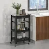 A black kitchen cart with shelves and a drawer is shown next to a kitchen counter with a sink and window. Náhled obrázku produktu