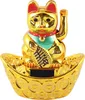 A golden lucky cat figurine sits on a boat-shaped base decorated with coins. Produktbild-Vorschau
