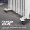 Close-up of the wheels and base of a white oil-filled radiator on a gray floor, with marketing text overlay. Náhled obrázku produktu