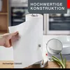 A hand is pulling a paper towel from a paper towel holder on a kitchen counter. Podgląd zdjęcia produktu