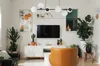 A living room scene with a TV, furniture, and plants. Náhled obrázku produktu