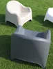 Several modern plastic chairs are placed on a grassy lawn. Produktbild-Vorschau