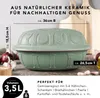 A green ceramic pot with decorative elements, placed on a surface with some ingredients like onions and garlic around it. Produktbild-Vorschau