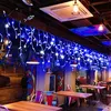 A dimly lit restaurant or cafe interior decorated with blue string lights and colorful murals. Náhľad obrázku produktu