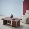 A living room scene with a coffee table, vase, ashtray, and a chair. Produktbild-Vorschau