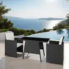 A rattan dining set for two is placed on a patio overlooking the sea and an infinity pool. Voir les images du produit