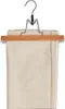 A pair of beige pants folded and hung on a wooden hanger with clips. Produktbild-Vorschau
