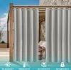 Outdoor curtains hanging on a wooden pergola structure, with a stone wall and furniture visible in the background. Produktbild-Vorschau