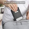 A person is placing a black electronic device into a gray bag. Produktbild-Vorschau