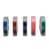 Five rolls of colored embossing tape in clear plastic dispensers are arranged in a row against a white background. Voir les images du produit