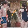 Children playing with a portable shower outdoors. Náhled obrázku produktu