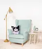 A plush toy is sitting on a mint green armchair next to two small side tables. A floor lamp is to the left of the chair. Voir les images du produit