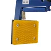 A close-up view of a blue and yellow stone lifting clamp. Náhled obrázku produktu