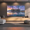 A living room scene with a TV mounted on the wall above a wooden media console. Podgląd zdjęcia produktu