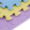 A close-up view of interlocking puzzle mats in blue, yellow, and purple. Voir les images du produit