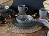 A table setting with stoneware dishes, mugs, and candles. Náhľad obrázku produktu