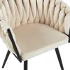 Close-up view of a beige velvet armchair with black legs. Produktbild-Vorschau