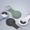 Four Apple AirTag holders in different colors are arranged on a light gray background. Produktbild-Vorschau