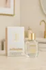 A perfume bottle and its box are displayed on a countertop in a bathroom setting. Produktbild-Vorschau