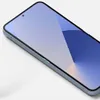 A close-up, angled view of a smartphone with a blue wallpaper on its screen. Produktbild-Vorschau