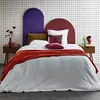 A bedroom scene with a bed, nightstands, and decorative elements. Produktbild-Vorschau