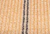 A close-up view of a beige fabric with two dark vertical stripes running through it. Produktbild-Vorschau