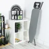 An ironing board is shown standing against a wall next to a white shelving unit. Náhľad obrázku produktu