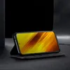 A smartphone in a flip case, displayed at an angle on a dark surface with a dark background. Produktbild-Vorschau