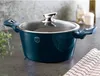 A teal pot with a glass lid sits on a countertop. Náhled obrázku produktu