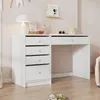 A white desk with drawers and a computer monitor, set against a light pink wall with decorations. Produktbild-Vorschau