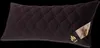 A dark brown quilted pillow with a label on the right side. Produktbild-Vorschau